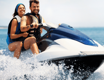 Happy couple riding on jet ski